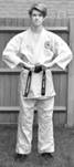 A person standing posing for the camera

Description automatically generated