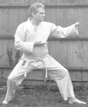 A person in a karate uniform

Description automatically generated with medium confidence