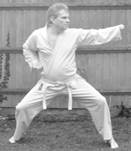 A person in a karate uniform

Description automatically generated with medium confidence