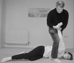 A person standing over a person lying on the ground

Description automatically generated with medium confidence