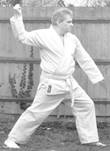 A person in a karate uniform

Description automatically generated with medium confidence